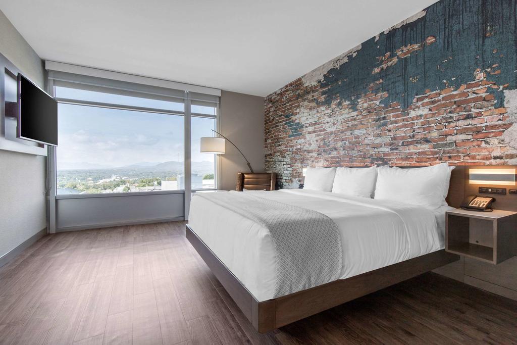 a room with large windows in the cambria hotel hotels in downtown asheville nc