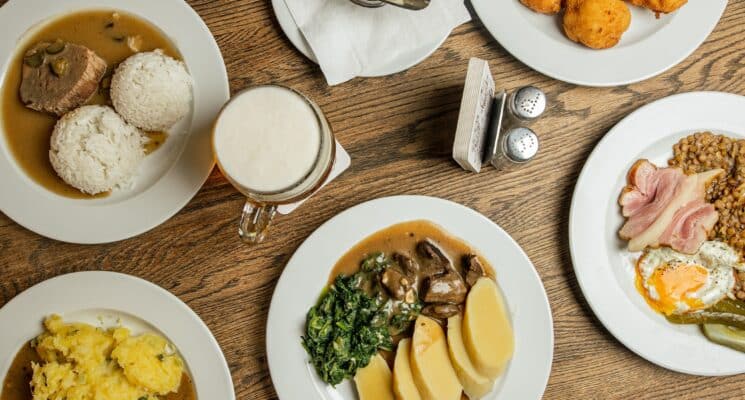 Various plates of traditional Czech food on a table in Prague