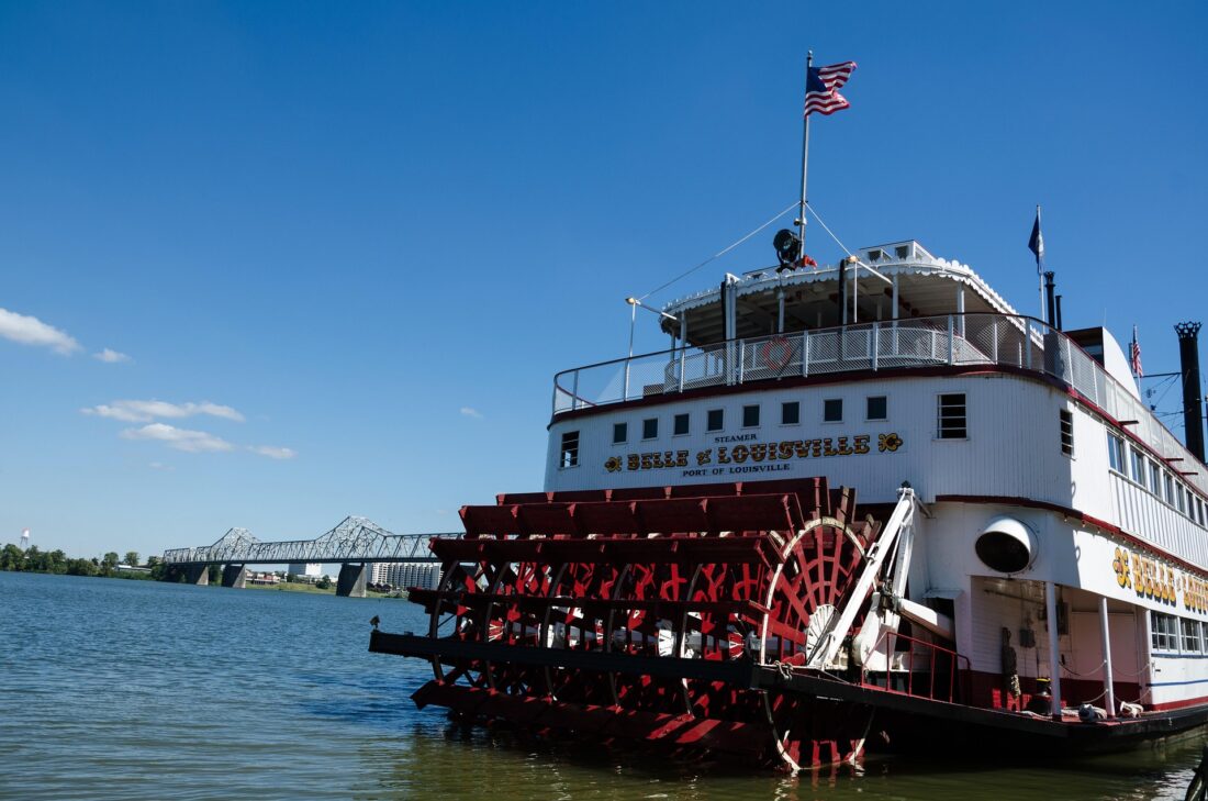 The Belle of Louisville steamboat on the river on a sunny day.