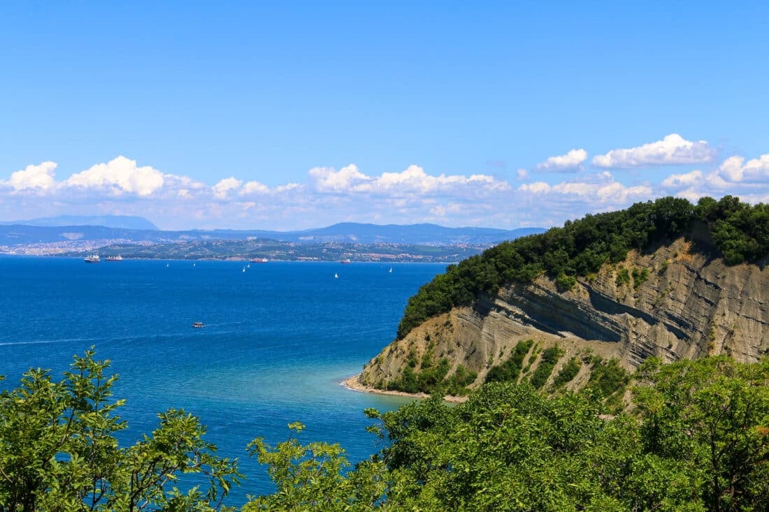 A secluded beach with a view of Italy's coastline in Koper, Slovenia.