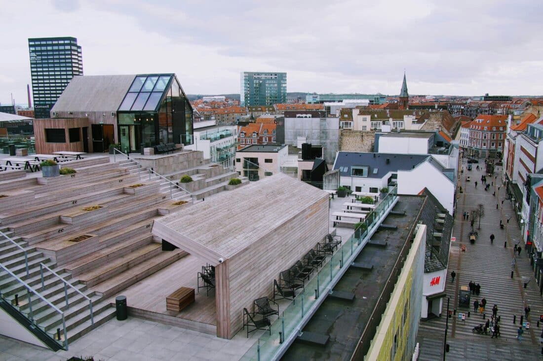 View of Aarhus from above, with a rooftop and spires in the distance.